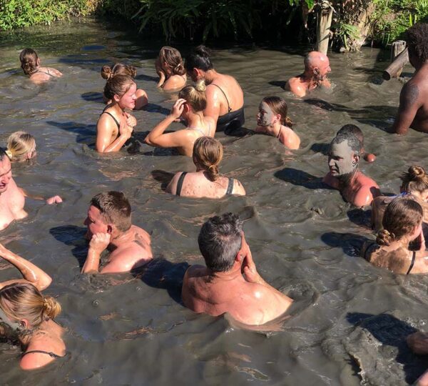Travellers soaking in the natural hot spring mud pool at Sabeto, Fiji